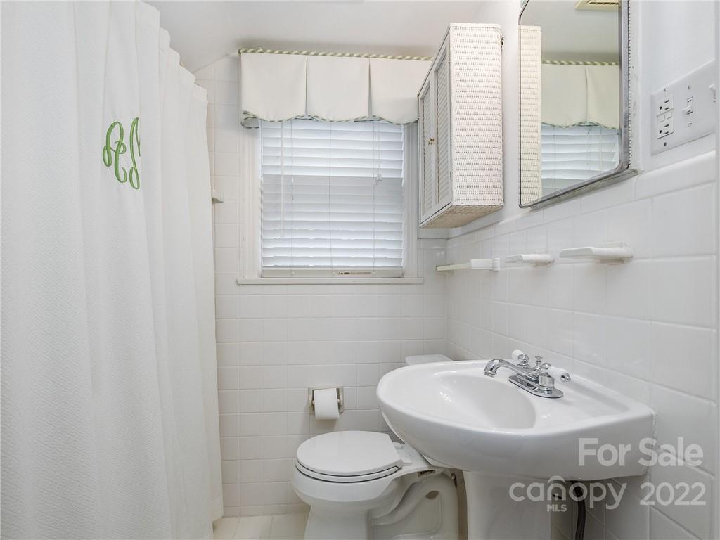 2701 Sharon Road Charlotte, NC 28211 - Photo 24 of 40 a bathroom with a sink a toilet and mirror