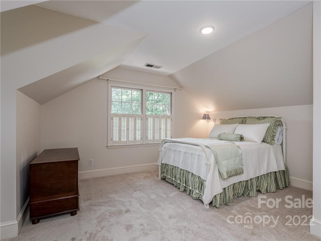 2701 Sharon Road Charlotte, NC 28211 - Photo 26 of 40 a bedroom with a bed and a lamp