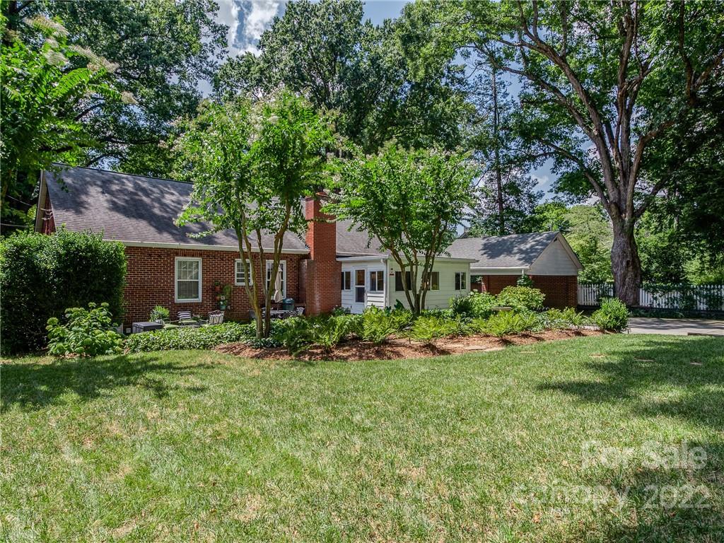 2701 Sharon Road Charlotte, NC 28211 - Photo 32 of 40 a view of a brick house with a big yard and large trees