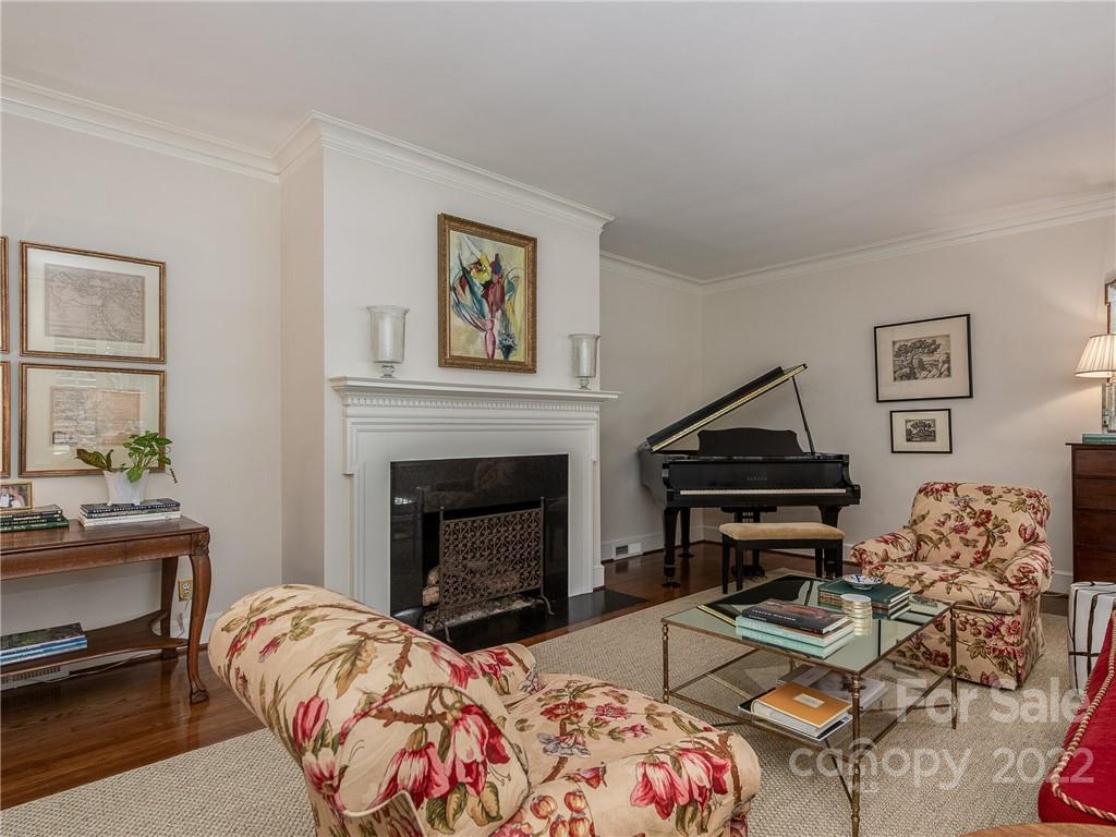 2701 Sharon Road Charlotte, NC 28211 - Photo 7 of 40 a bedroom with a bed and a fireplace