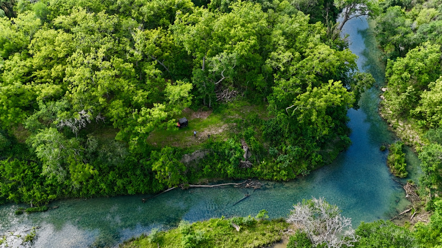 1175 Southern Way Luling, TX 78648 - Photo 7 of 40 A tranquil water view with a clear river meandering through lush, verdant trees.