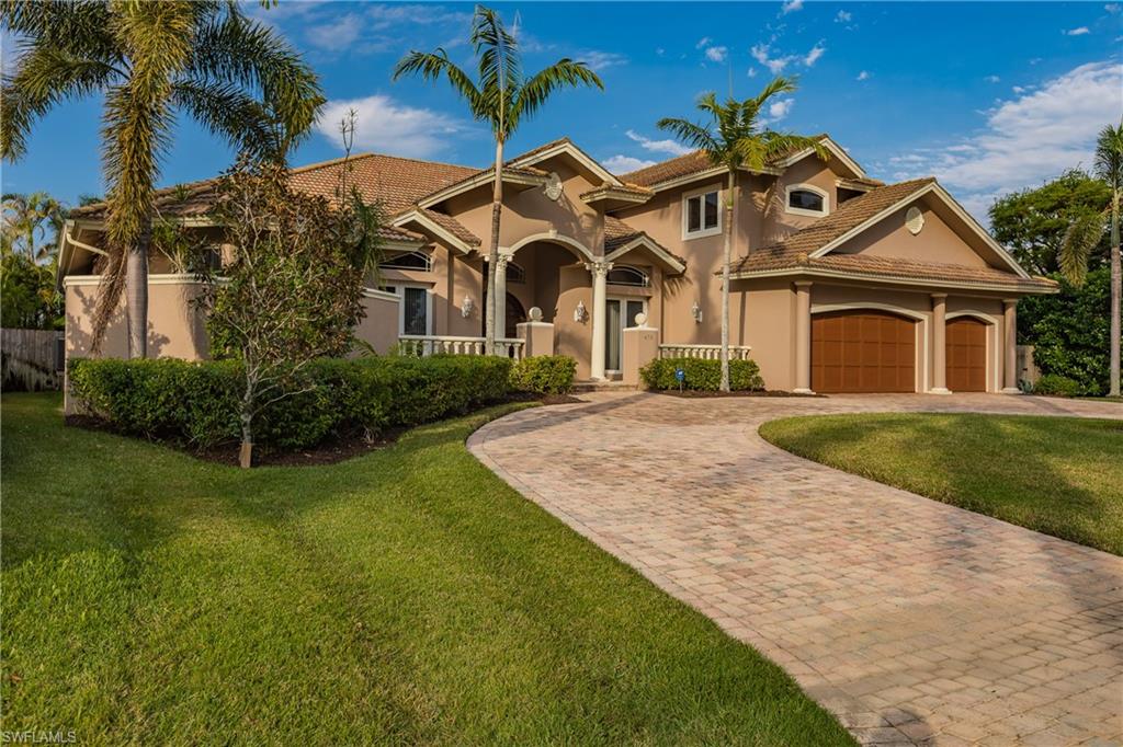 475 Wedge Drive Naples, FL 34103 - Photo 1 of 1 front view of a house with a yard