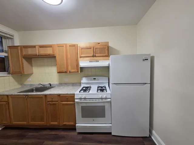 a kitchen with a white cabinets and white appliances