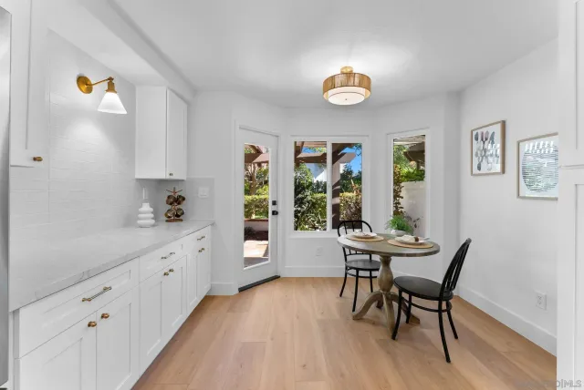 a view of a dining room with furniture a chandelier and wooden floor