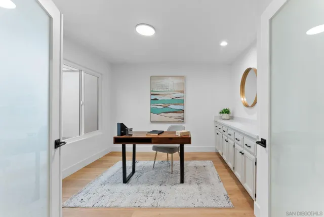 a view of a workspace area with furniture and wooden floor