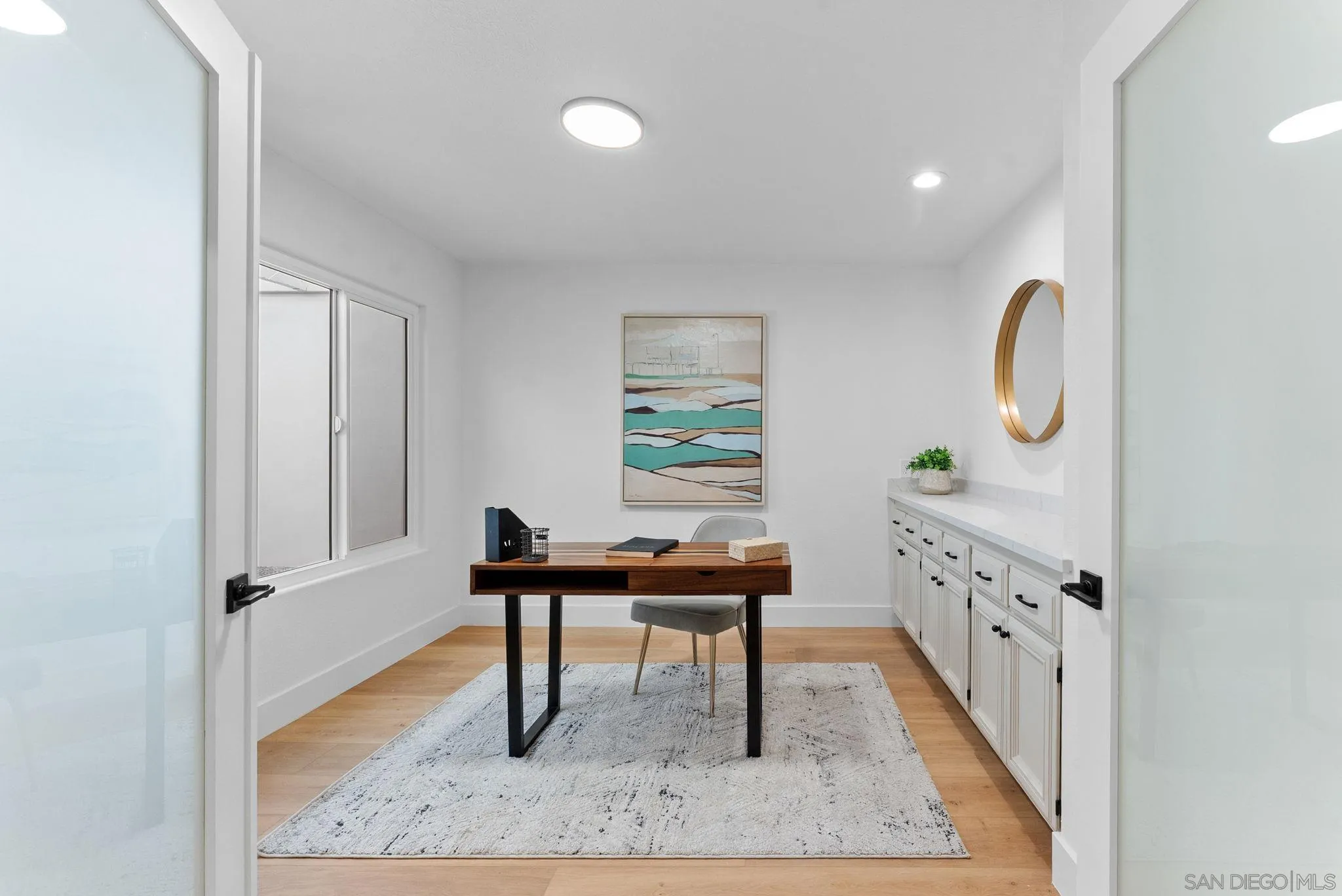 4946 Alicante Way Oceanside, CA 92056 - Photo 15 of 34 a view of a workspace area with furniture and wooden floor