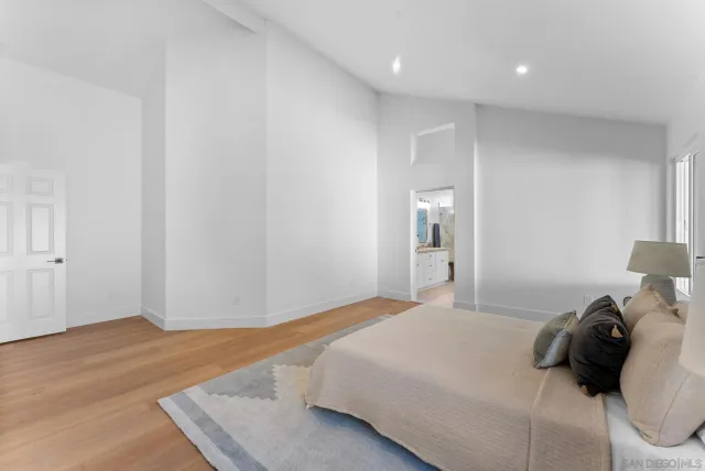 a bedroom with a bed and a night stand