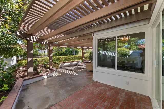 a view of a porch with furniture and a backyard
