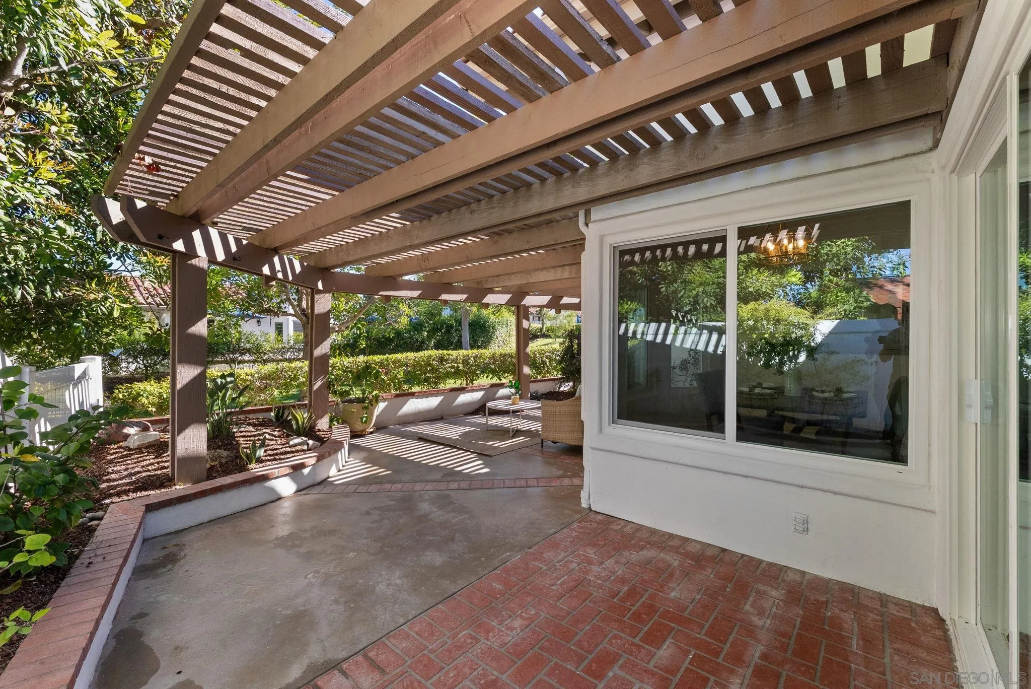 4946 Alicante Way Oceanside, CA 92056 - Photo 26 of 34 a view of a porch with furniture and a backyard