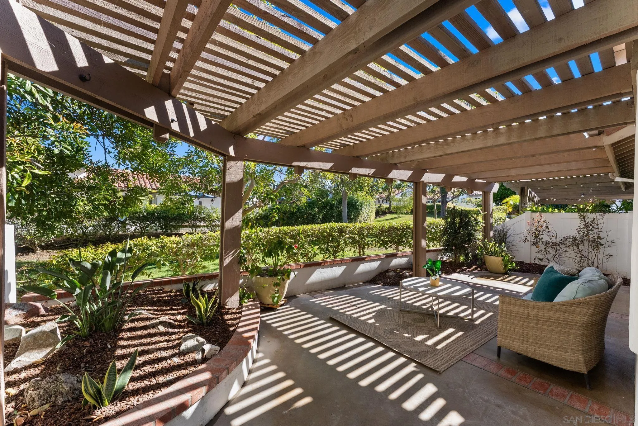 4946 Alicante Way Oceanside, CA 92056 - Photo 27 of 34 a view of a patio with couches plants and large trees