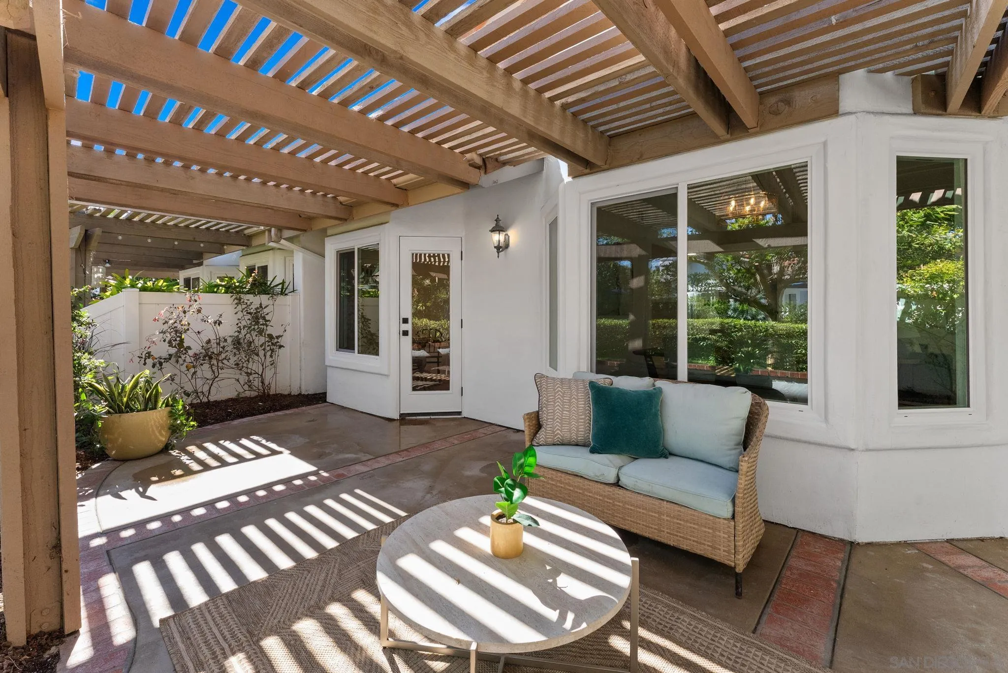 4946 Alicante Way Oceanside, CA 92056 - Photo 29 of 34 a outdoor living space with furniture and a potted plant