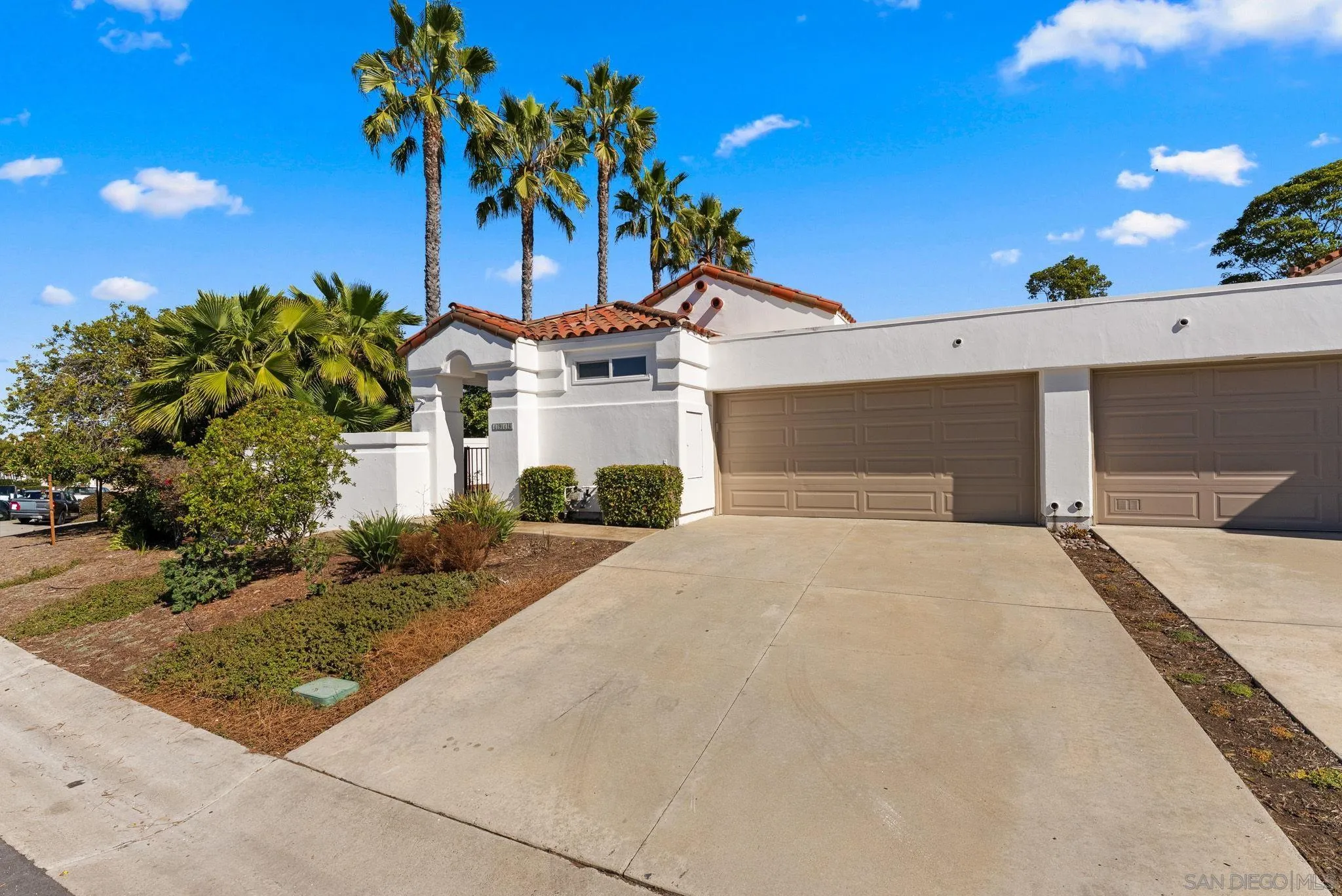4946 Alicante Way Oceanside, CA 92056 - Photo 31 of 34 a front view of a house with a yard and garage