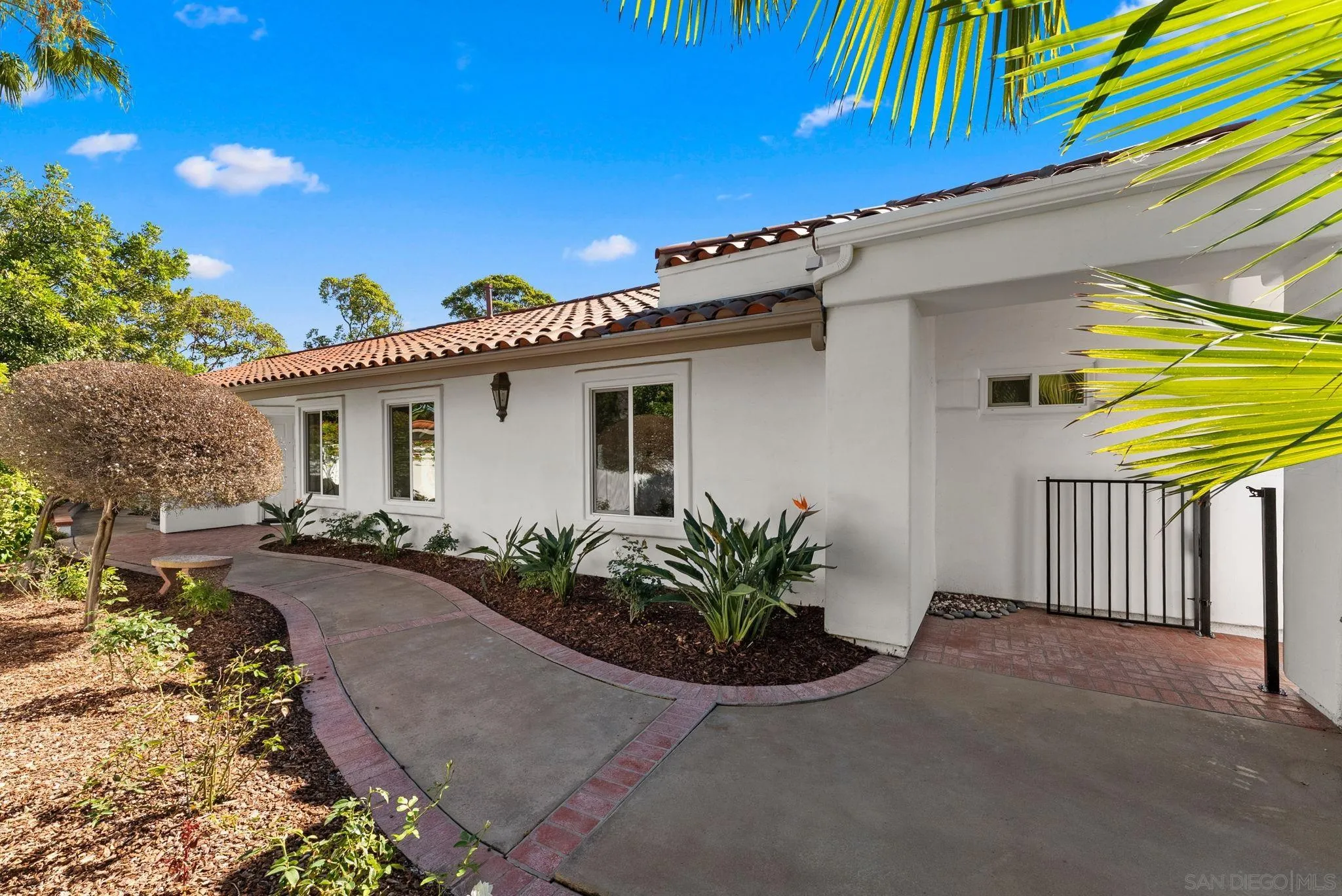 4946 Alicante Way Oceanside, CA 92056 - Photo 32 of 34 a front view of a house with garden