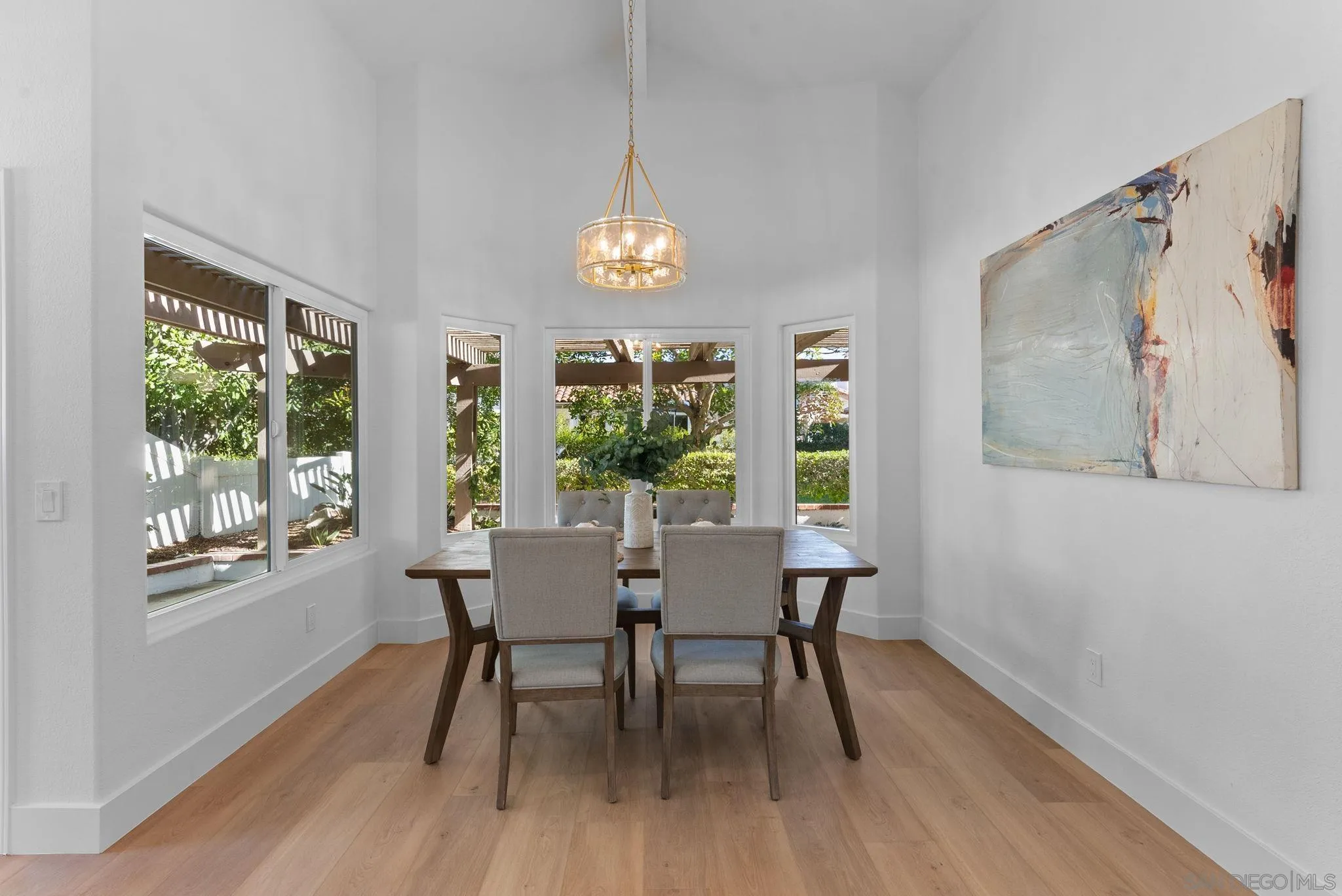4946 Alicante Way Oceanside, CA 92056 - Photo 9 of 34 a view of a dining room with furniture window and wooden floor