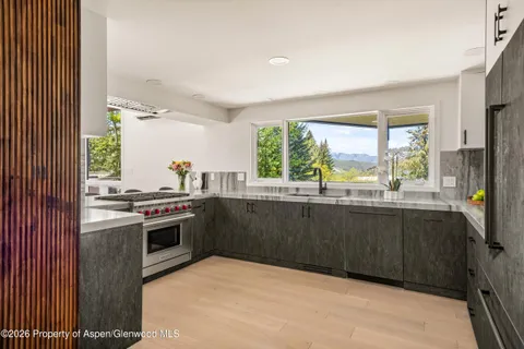 a kitchen with a stove a sink and a refrigerator