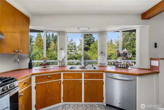 a kitchen with a sink and a stove top oven