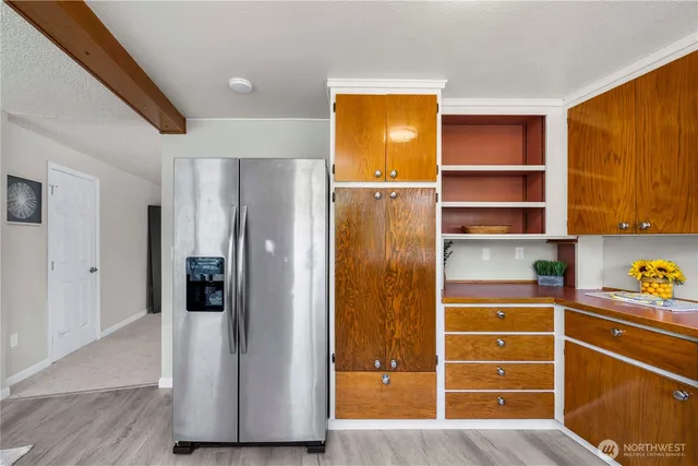a view of walk in closet with window and wooden floor
