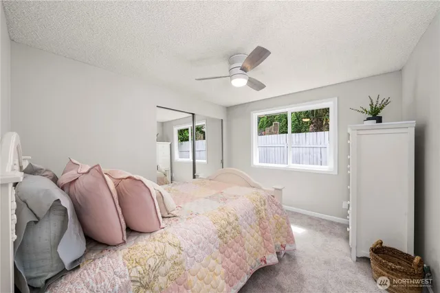 a bedroom with a bed and a window