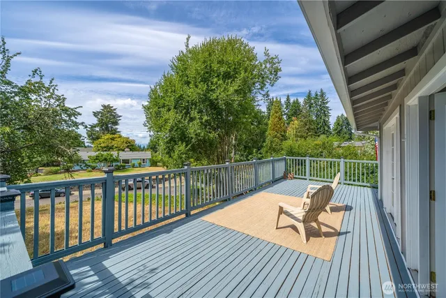a view of balcony with wooden floor and outdoor seating