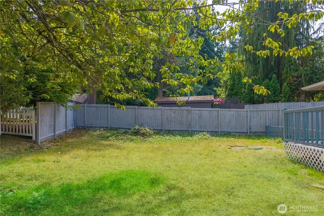 a view of swimming pool with wooden fence