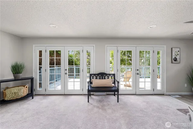 a living room with furniture and large windows