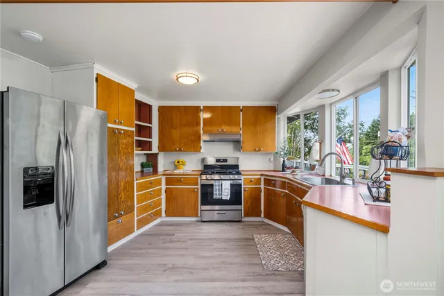 a kitchen with stainless steel appliances granite countertop a stove and a refrigerator