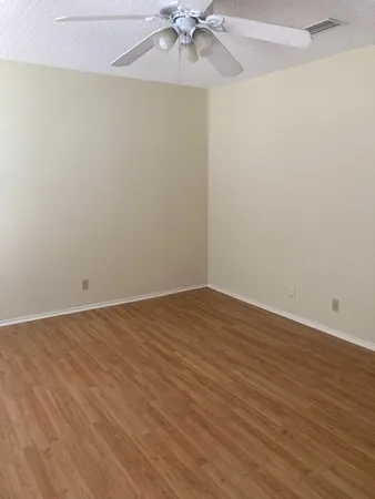 a view of an empty room with a fan