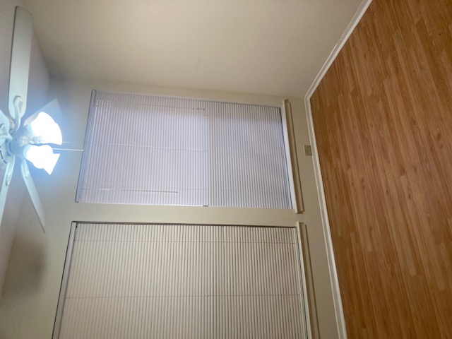 3115 Helms Street, Unit 302 Austin, TX 78705 - Photo 4 of 9 a view of an empty room with wooden floor and a window