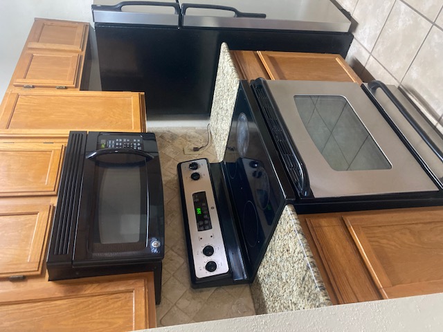 3115 Helms Street, Unit 302 Austin, TX 78705 - Photo 5 of 9 a kitchen with a stove microwave and refrigerator