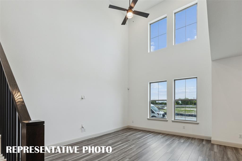 220 Dylan Way Midlothian, TX 76065 - Photo 3 of 16 Featuring volume windows in the family room, this beautiful home is filled with natural light. REPRESENTATIVE PHOTO