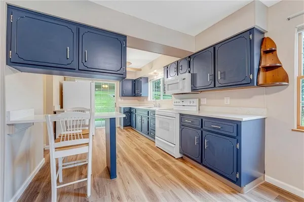 a kitchen with wooden cabinets and center island