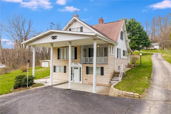 a view of house with outdoor space and garden
