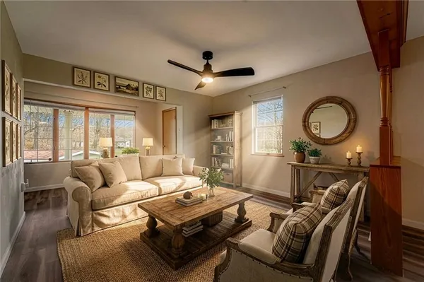 a living room with furniture a rug and a large window
