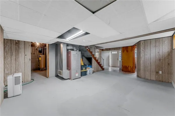 a view of an empty room with closet and a window
