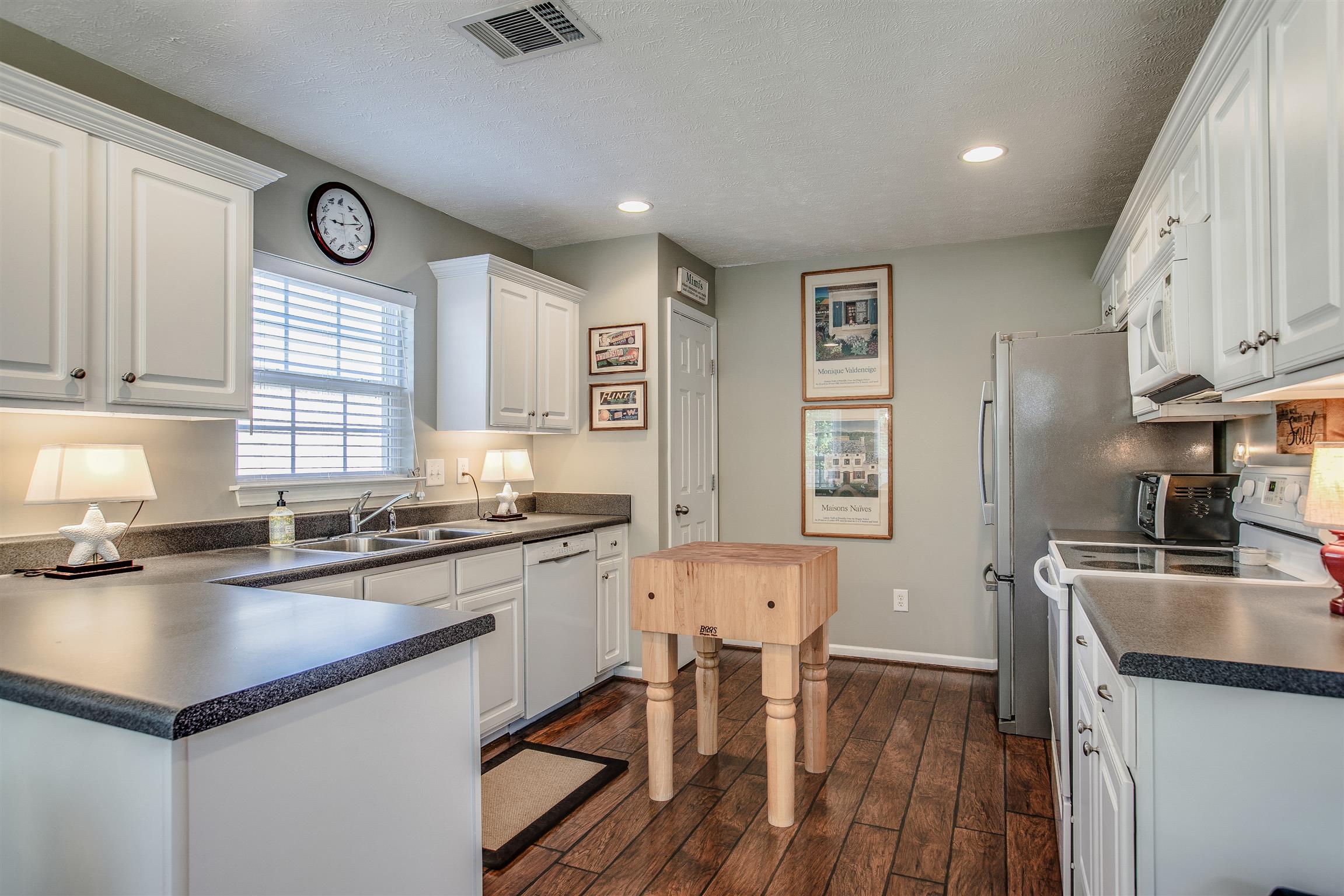 2008 Fiona Way Spring Hill, TN 37174 - Photo 7 of 20 Spacious kitchen with white cabinetry and a lookout window over the sink. Plus a pantry and a fancy Bosch dishwasher!