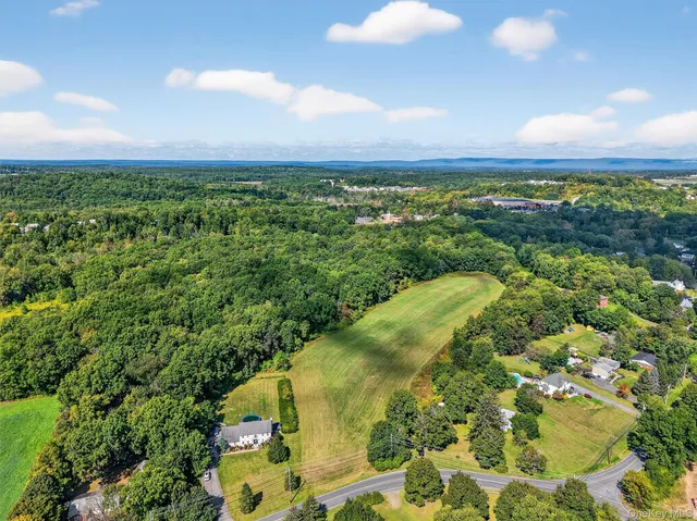 an aerial view of a houses with a yard