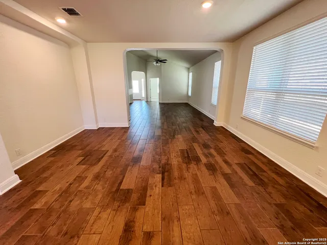 a view of an empty room and wooden floor