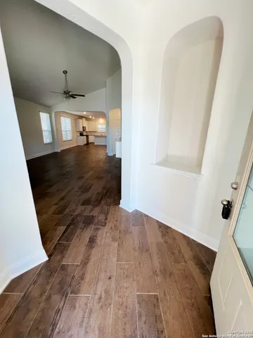a view of entryway and hall with wooden floor