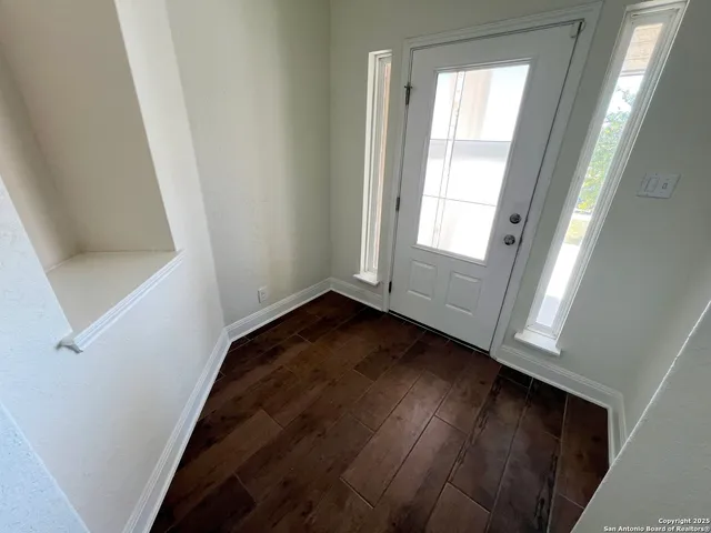 a view of a small space with wooden floor and staircase