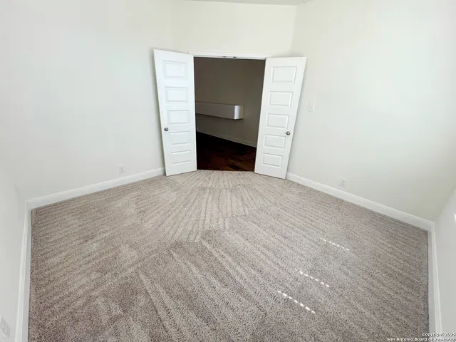 a view of an empty room with a fireplace