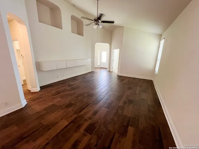 wooden floor in an empty room with a window