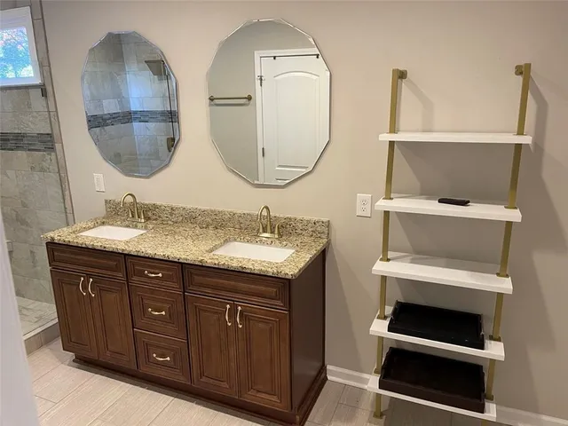 a bathroom with a double vanity sink and a mirror