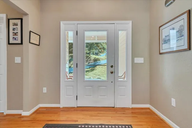a view of a room with wooden floor and white walls