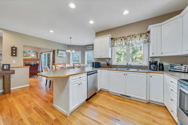 a kitchen with a sink window and cabinets