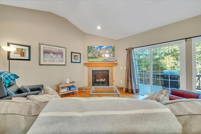 a living room with furniture a window and a fireplace