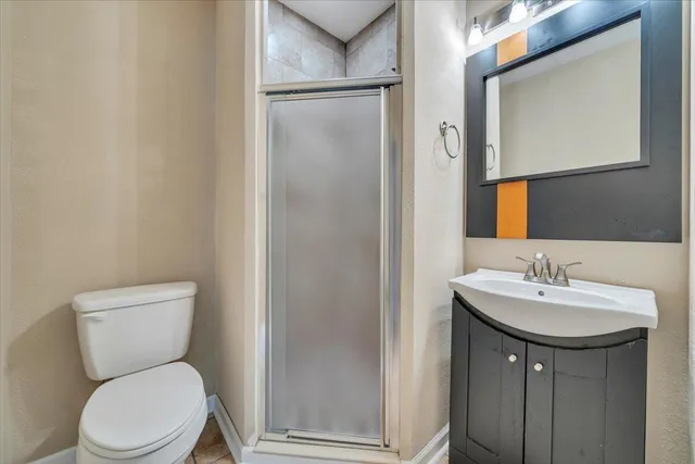 a bathroom with a toilet a sink and mirror