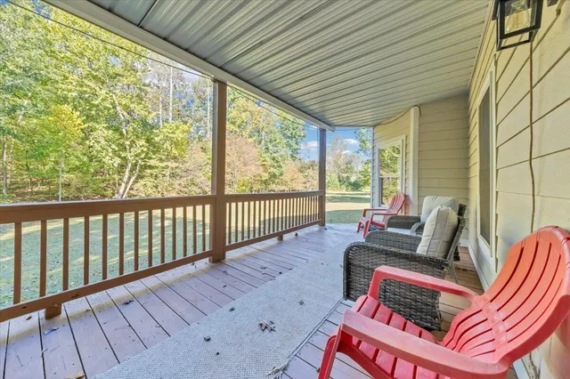 a balcony with wooden floor and furniture
