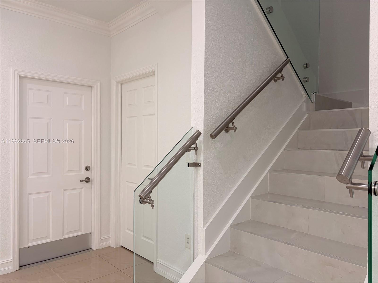 14738 Southwest 22nd Terrace Miami, FL 33185 - Photo 11 of 46 a view of staircase with white walls and white walls