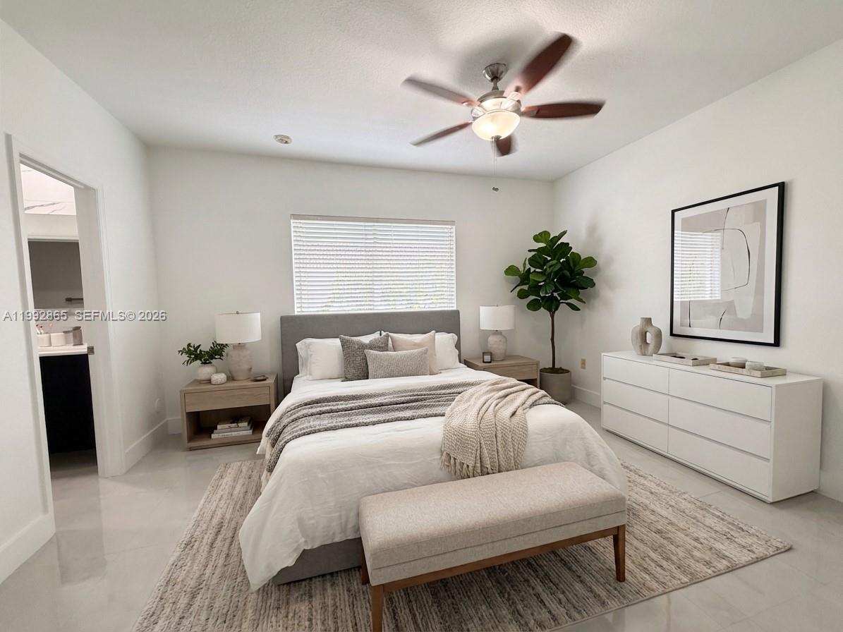 14738 Southwest 22nd Terrace Miami, FL 33185 - Photo 12 of 46 a spacious bedroom with a large bed couch and windows