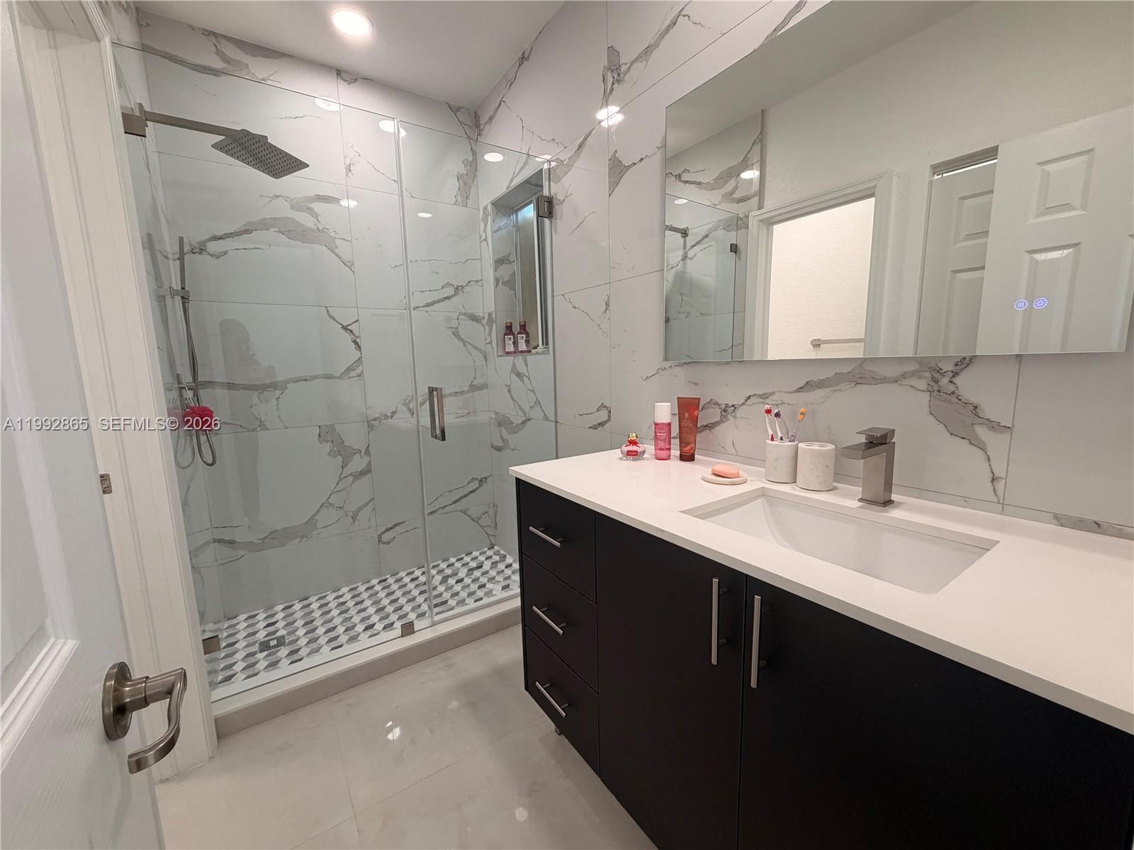 14738 Southwest 22nd Terrace Miami, FL 33185 - Photo 14 of 46 a bathroom with a shower sink and mirror